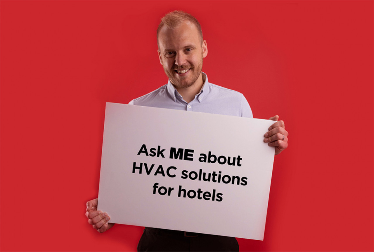 James Harman holding ASK ME about Hotels sign