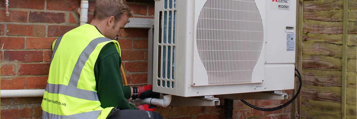 Maintenance engineer reviewing outdoor heat pump 