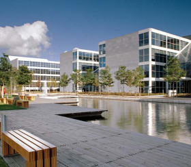 Exterior of office buildings with a large pond