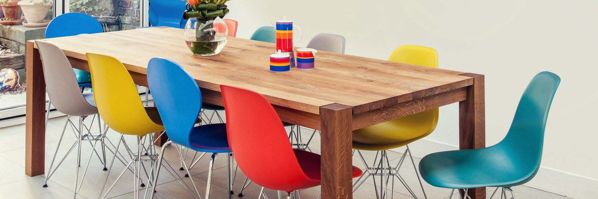 Dining table in living room with colourful chairs